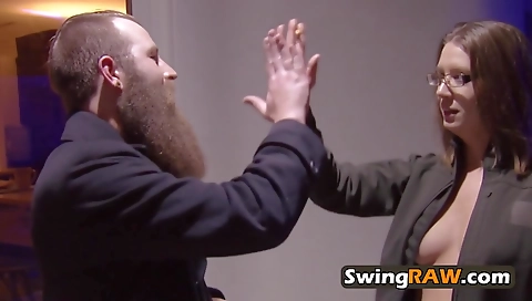 Jess is playing with John's dick in a group sex scene