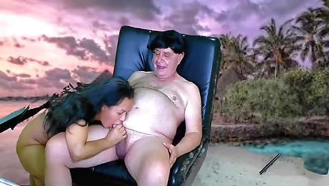 Asian brunette with a beautiful face is giving a hot blowjob