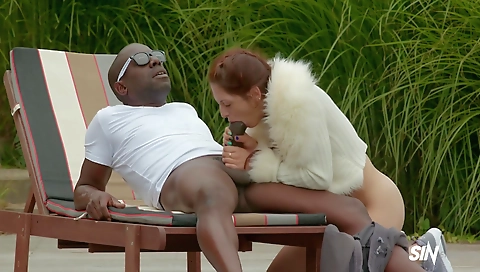 Interracial milf with hairy pussy gets fucked in the surf