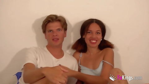 Tattooed brunette teen plays with a big fake pecker