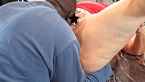 Mature woman in a skimpy blouse and a sexy red dress